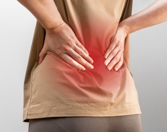 Someone holding their back in pain