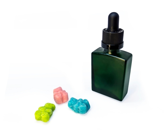 CBD gummies next to oil bottle