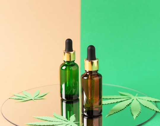 CBD oil bottles on a glass tray
